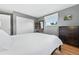 This bedroom features gray walls, a closet, and a dresser atop hardwood floors at 2011 S Vallejo St, Denver, CO 80223