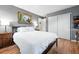 Cozy bedroom with hardwood floors, a comfortable bed, and ample closet space at 2011 S Vallejo St, Denver, CO 80223