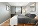 Neutral bedroom featuring hardwood floors, modern gray walls, and natural light from a window at 2011 S Vallejo St, Denver, CO 80223