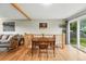 Dining area with hardwood floors, seating for four, and access to the backyard through sliding glass doors at 2011 S Vallejo St, Denver, CO 80223