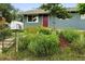 Charming single-story home with a well-manicured front yard, colorful flowers, and a classic mailbox at 2011 S Vallejo St, Denver, CO 80223