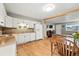 Bright kitchen with white cabinets and view to the open-concept dining and living areas at 2011 S Vallejo St, Denver, CO 80223