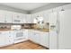 Efficient kitchen with white cabinets, appliances, and plenty of storage at 2011 S Vallejo St, Denver, CO 80223