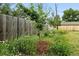 Lush landscaping featuring a variety of plants and a wooden fence at 2011 S Vallejo St, Denver, CO 80223