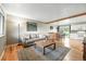 Inviting living room and kitchen area featuring an open layout, hardwood floors, and neutral decor at 2011 S Vallejo St, Denver, CO 80223