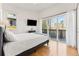 Sunlit bedroom with balcony access and wood floors at 1820 Mary Ln # 1, Boulder, CO 80304