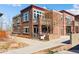 Attractive townhome with brick facade, second story balcony, and walkway with landscaped features at 1820 Mary Ln # 1, Boulder, CO 80304