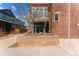View of patio with hanging hammocks and brick retaining wall with small garden area at 1820 Mary Ln # 1, Boulder, CO 80304