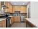 Well-equipped kitchen with stainless steel appliances, mosaic tile backsplash, and light wood cabinetry at 1820 Mary Ln # 1, Boulder, CO 80304