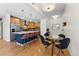Bright kitchen island with stainless steel appliances, dining table with seating, and hardwood flooring at 1820 Mary Ln # 1, Boulder, CO 80304