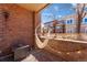Relaxing covered patio with hanging hammock chair, brick wall and string lights at 1820 Mary Ln # 1, Boulder, CO 80304