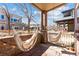 Cozy outdoor patio featuring hanging hammock chairs with string lights, and a brick retaining wall at 1820 Mary Ln # 1, Boulder, CO 80304
