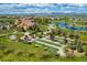 Aerial view of the community clubhouse, bocce ball court, lush landscaping, and community lakes at 15720 Columbus Mountain Dr, Broomfield, CO 80023