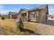 Charming backyard with well-maintained lawn, tasteful landscaping, and a covered patio at 15720 Columbus Mountain Dr, Broomfield, CO 80023