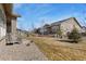 Expansive backyard featuring manicured lawn and mature trees offering shade and privacy at 15720 Columbus Mountain Dr, Broomfield, CO 80023