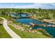 Community pond featuring footbridge, pathways, natural stone accents, and native vegetation at 15720 Columbus Mountain Dr, Broomfield, CO 80023