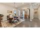 Open dining room showing coffered ceilings, hardwood floors and decorator touches at 15720 Columbus Mountain Dr, Broomfield, CO 80023