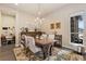 Bright dining room with a chandelier, view from the window, and area for a study at 15720 Columbus Mountain Dr, Broomfield, CO 80023