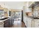 Gourmet kitchen showcasing stainless steel appliances, granite countertops, and an adjacent dining area at 15720 Columbus Mountain Dr, Broomfield, CO 80023