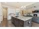 Open-concept kitchen with a large island, granite countertops, and seamless flow to the living area at 15720 Columbus Mountain Dr, Broomfield, CO 80023
