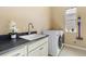 Functional laundry room with modern appliances, counter space, and natural light at 15720 Columbus Mountain Dr, Broomfield, CO 80023