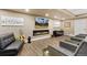 Cozy basement living room featuring a fireplace, large screen TV, and stylish decor at 15720 Columbus Mountain Dr, Broomfield, CO 80023
