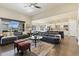 Open concept living room with hardwood floors, an island with bar seating, and kitchen at 15720 Columbus Mountain Dr, Broomfield, CO 80023