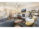 Large living room with fireplace, hardwood floors, and a large picture window at 15720 Columbus Mountain Dr, Broomfield, CO 80023