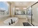 Luxurious main bathroom featuring a soaking tub, a separate shower, and dual vanities at 15720 Columbus Mountain Dr, Broomfield, CO 80023