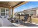 Relaxing covered patio with comfortable seating and charming string lights at 15720 Columbus Mountain Dr, Broomfield, CO 80023