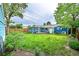 House with blue siding, a sun room, lush green grass, and a shed at 1720 Trenton St, Denver, CO 80220