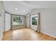 Bedroom features shiplap wall, hardwood floors, and natural light from two windows at 1720 Trenton St, Denver, CO 80220