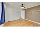 The bedroom features hardwood floors, a ceiling fan, fresh paint, and a closet for storage at 1720 Trenton St, Denver, CO 80220