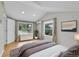 Bright bedroom features shiplap accent wall, hardwood floors, and natural light from two windows at 1720 Trenton St, Denver, CO 80220