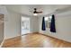 Bright bedroom features hardwood flooring, ceiling fan, and mini split at 1720 Trenton St, Denver, CO 80220