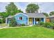 Charming blue bungalow featuring a well-manicured lawn and inviting front porch at 1720 Trenton St, Denver, CO 80220
