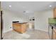 Open kitchen layout with an island, stainless steel appliances, and tile flooring at 1720 Trenton St, Denver, CO 80220