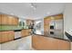 Updated kitchen with stainless steel appliances, green backsplash, and a kitchen island at 1720 Trenton St, Denver, CO 80220