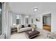 Living room is bright with many windows, a sofa, and comfortable, plush seating at 1720 Trenton St, Denver, CO 80220