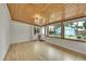 Bright sunroom features wood ceilings, hardwood flooring, and an abundance of natural light at 1720 Trenton St, Denver, CO 80220