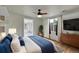 Bright main bedroom features a ceiling fan, window with curtains, and a lovely hardwood floor at 1720 Trenton St, Denver, CO 80220