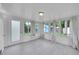 Bright sun room with walls of windows and a door leading to the backyard at 1720 Trenton St, Denver, CO 80220