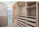 Spacious walk-in closet with custom built-in shelving and drawers for optimal storage at 720 16Th St # 306, Denver, CO 80202