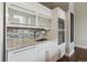 Sleek, white kitchen featuring modern appliances, mosaic tile backsplash, and ample counter space at 720 16Th St # 306, Denver, CO 80202
