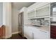 Modern kitchen with white cabinets, stainless steel appliances, and mosaic tile backsplash at 720 16Th St # 306, Denver, CO 80202