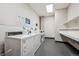 Bright laundry room with multiple washing machines and folding counter at 720 16Th St # 306, Denver, CO 80202