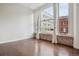 Bright living room featuring hardwood floors, exposed brick, and large windows with city views at 720 16Th St # 306, Denver, CO 80202