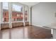 Sunlit living room showcasing hardwood floors, large windows and exposed brick, offering great city views at 720 16Th St # 306, Denver, CO 80202