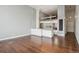 Spacious open-concept living room with hardwood floors and bright kitchen with white cabinetry at 720 16Th St # 306, Denver, CO 80202