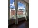 Stunning city views through large windows, showcasing historic brick building, hardwood floors, and custom curtains at 720 16Th St # 306, Denver, CO 80202